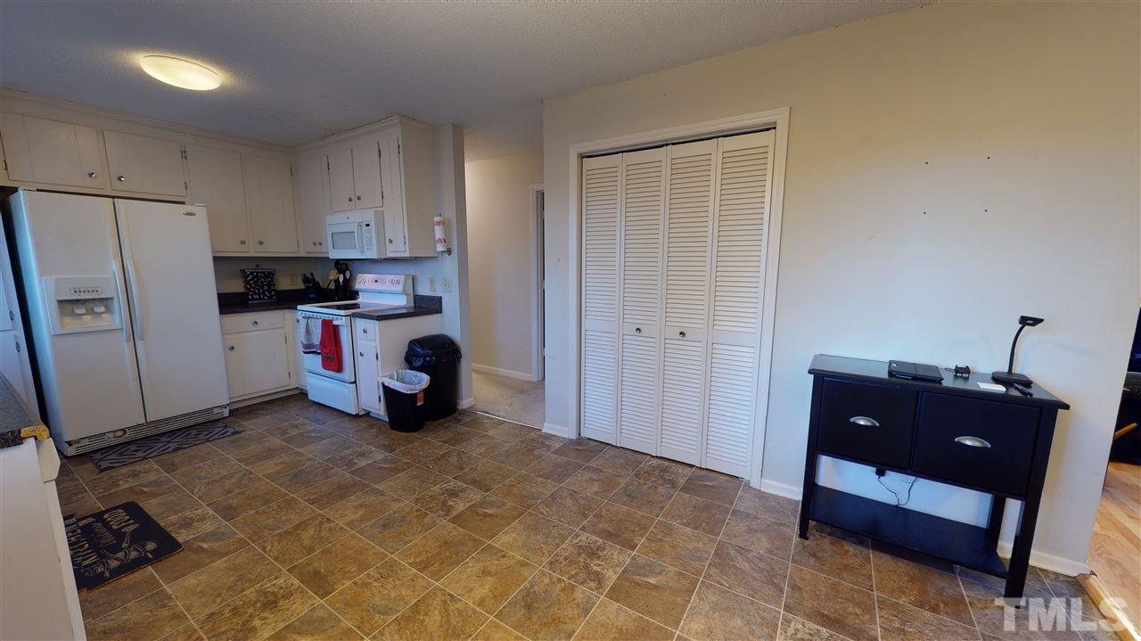1503 Cole Mill Road Durham, NC 27705 - Photo 9 of 29 a view of kitchen with refrigerator and window