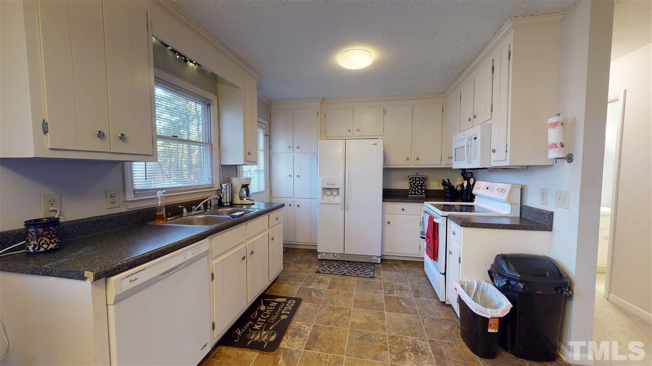 1503 Cole Mill Road Durham, NC 27705 - Photo 10 of 29 a kitchen with a sink stove and refrigerator