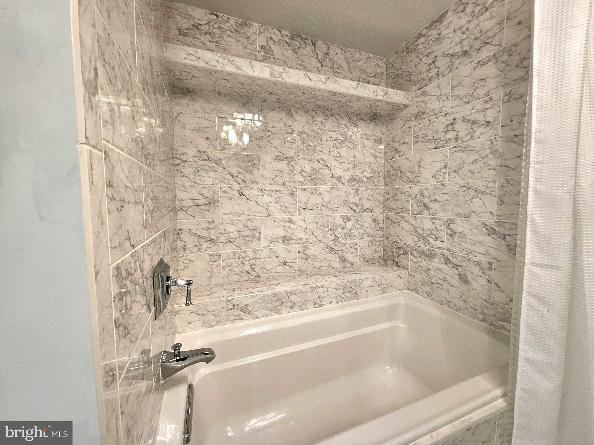 1080 Wisconsin Avenue Northwest, Unit 103/104 Washington, DC 20007 - Photo 17 of 37 a close up of a bathtub in bathroom