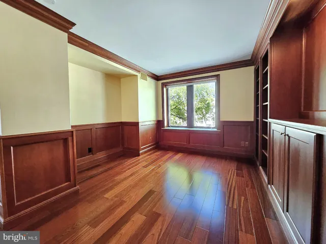 a view of wooden floor and windows in a room