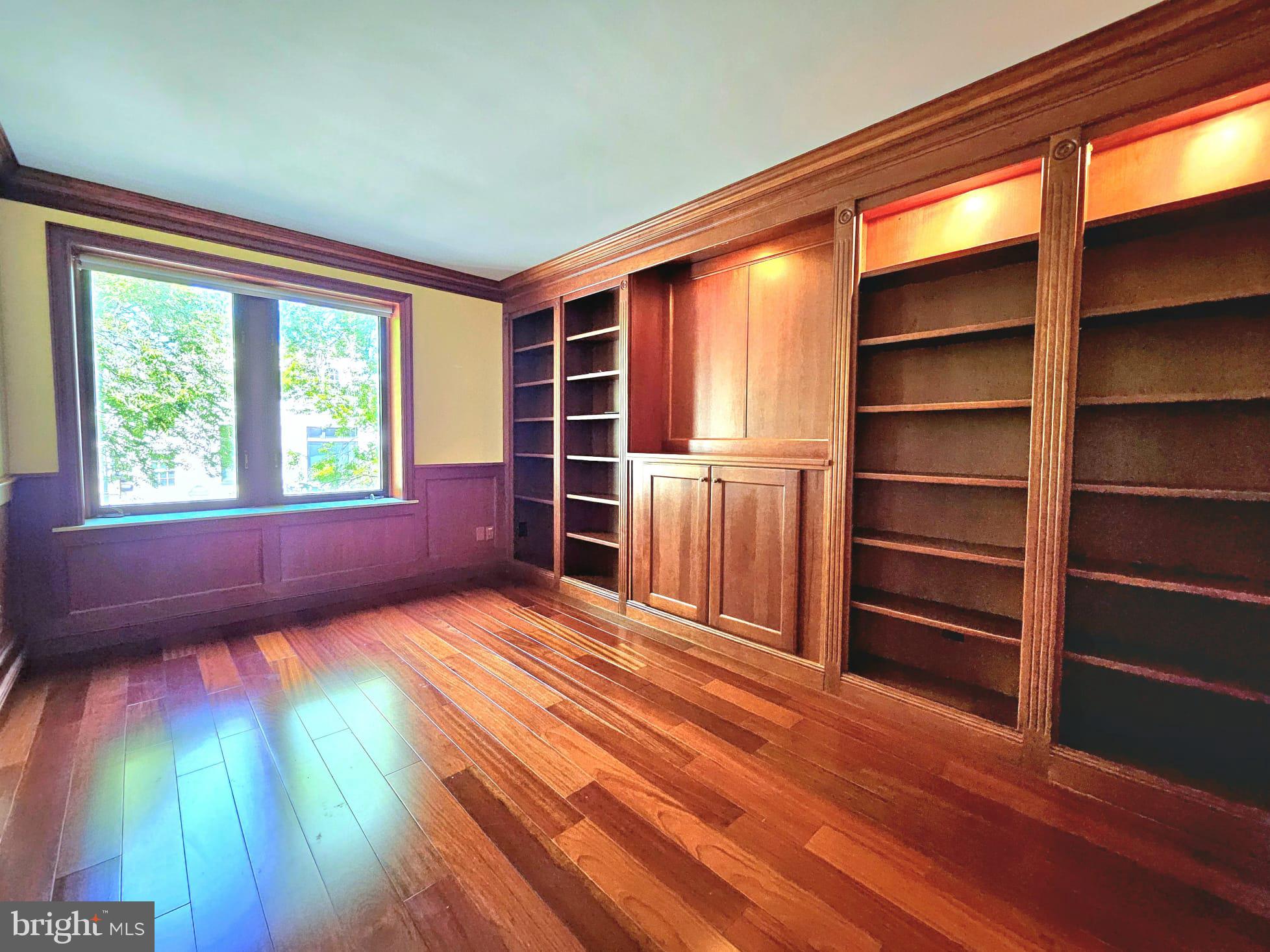 1080 Wisconsin Avenue Northwest, Unit 103/104 Washington, DC 20007 - Photo 23 of 37 a view of an empty room with a window and wooden floor