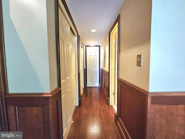 a view of hallway with wooden floor