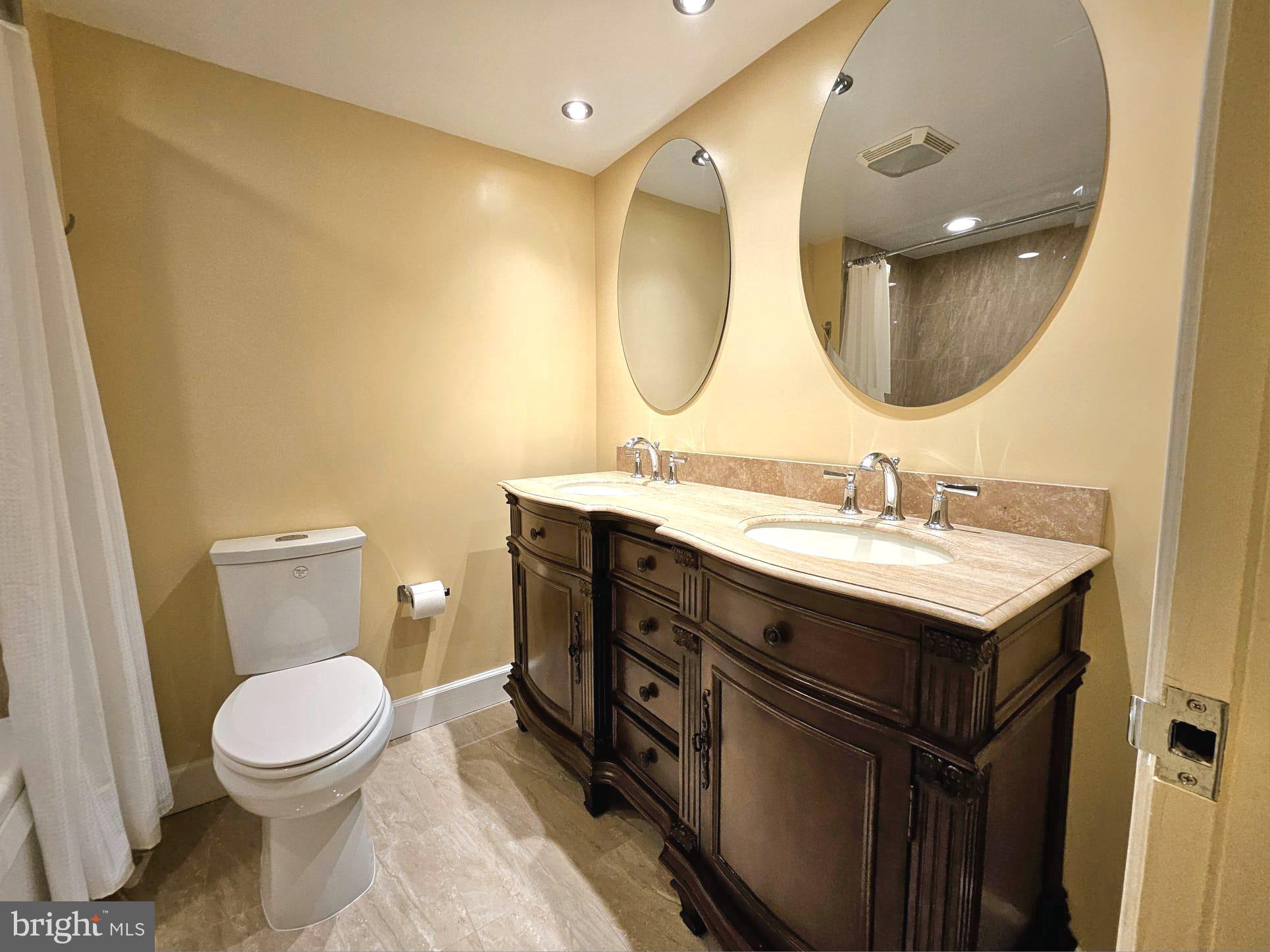 1080 Wisconsin Avenue Northwest, Unit 103/104 Washington, DC 20007 - Photo 25 of 37 a bathroom with a toilet a sink and mirror