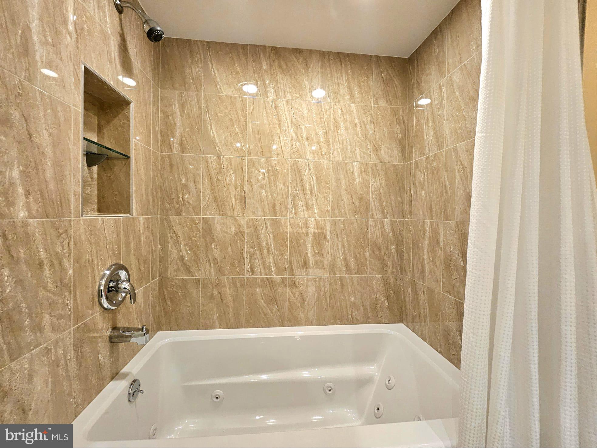 1080 Wisconsin Avenue Northwest, Unit 103/104 Washington, DC 20007 - Photo 26 of 37 a bathroom with a bathtub
