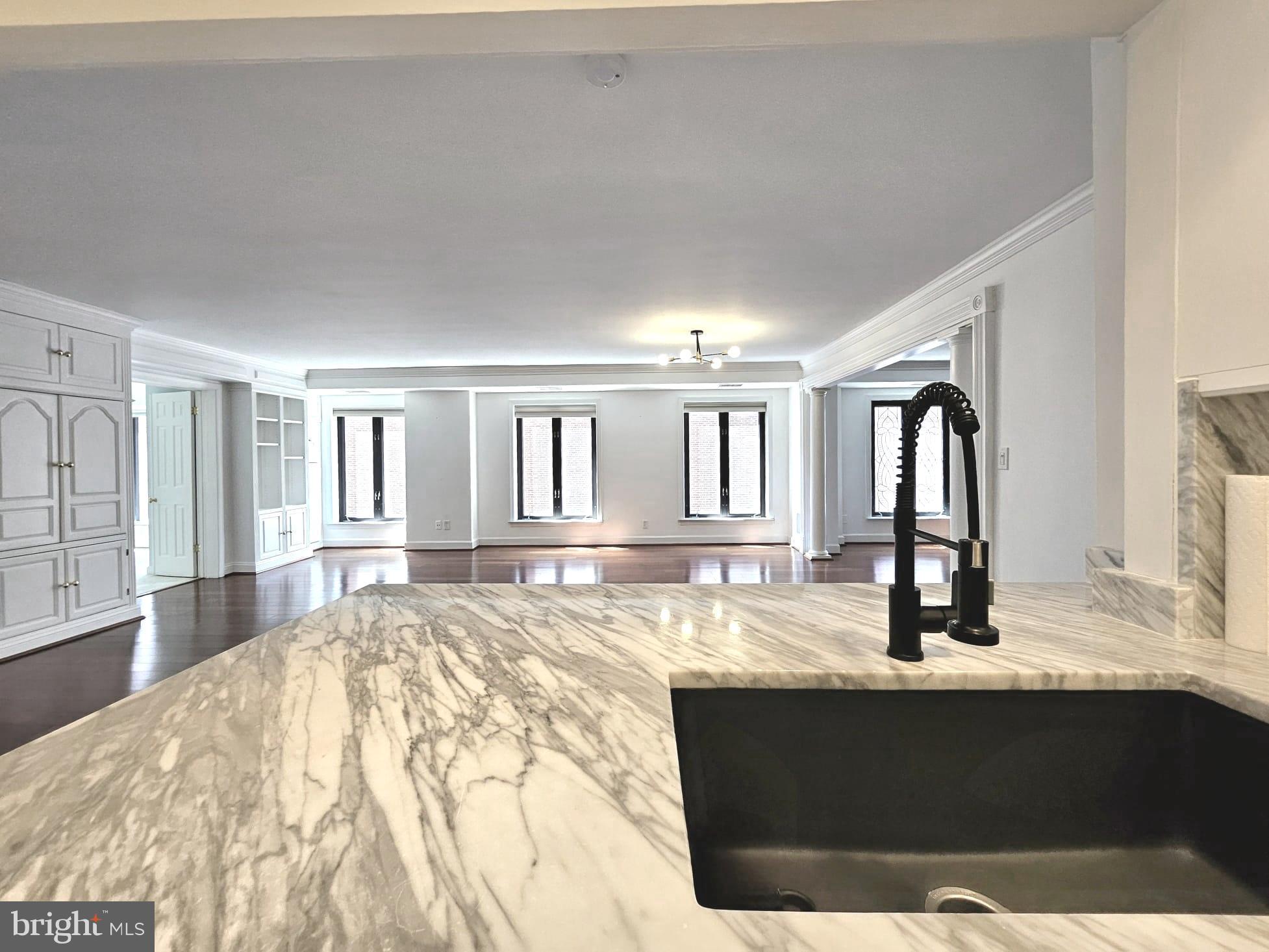 1080 Wisconsin Avenue Northwest, Unit 103/104 Washington, DC 20007 - Photo 5 of 37 a view of living room with granite countertop furniture and fireplace