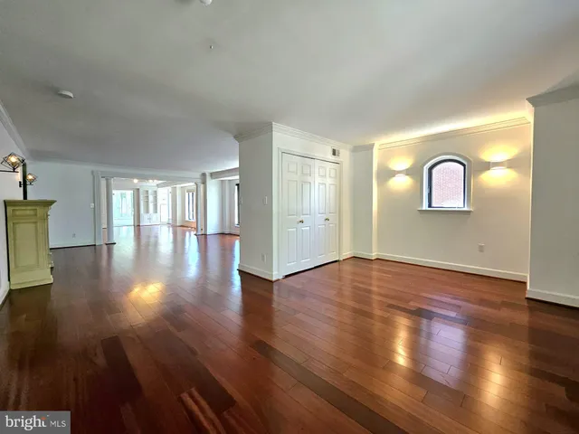 a view of empty room with wooden floor