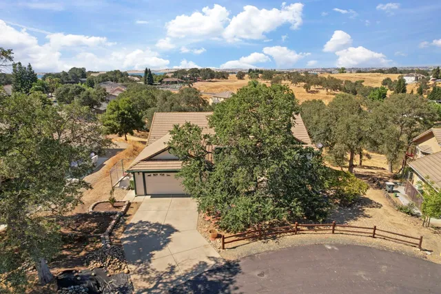 a view of a house with a tree in the background