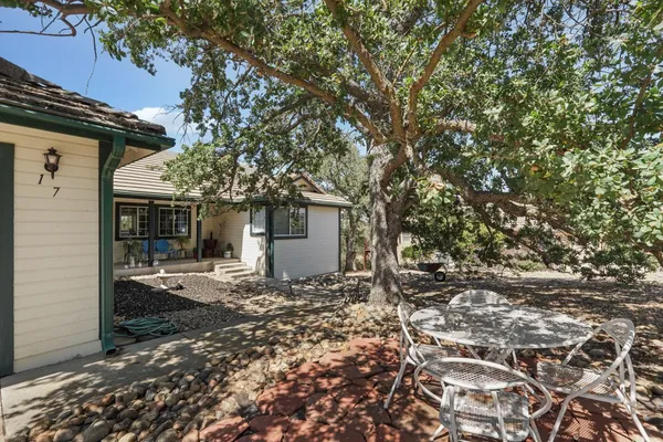 a view of a house with a tree in the background