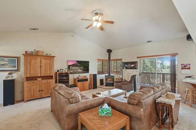 a kitchen with stainless steel appliances granite countertop a stove refrigerator and dining table