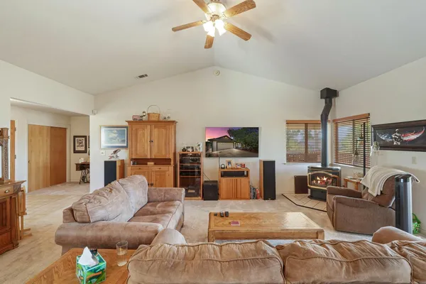 a kitchen with stainless steel appliances granite countertop a stove refrigerator and dining table