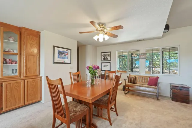 a living room with furniture large window and wooden floor