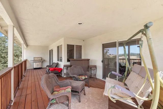 an aerial view of house with yard and ocean view in back