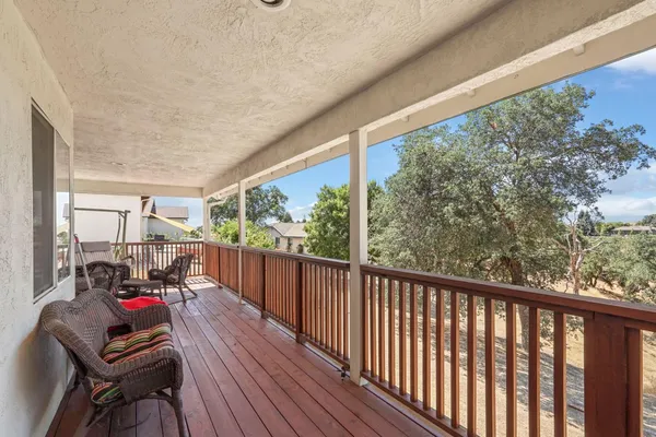 a view of a two chairs in the balcony