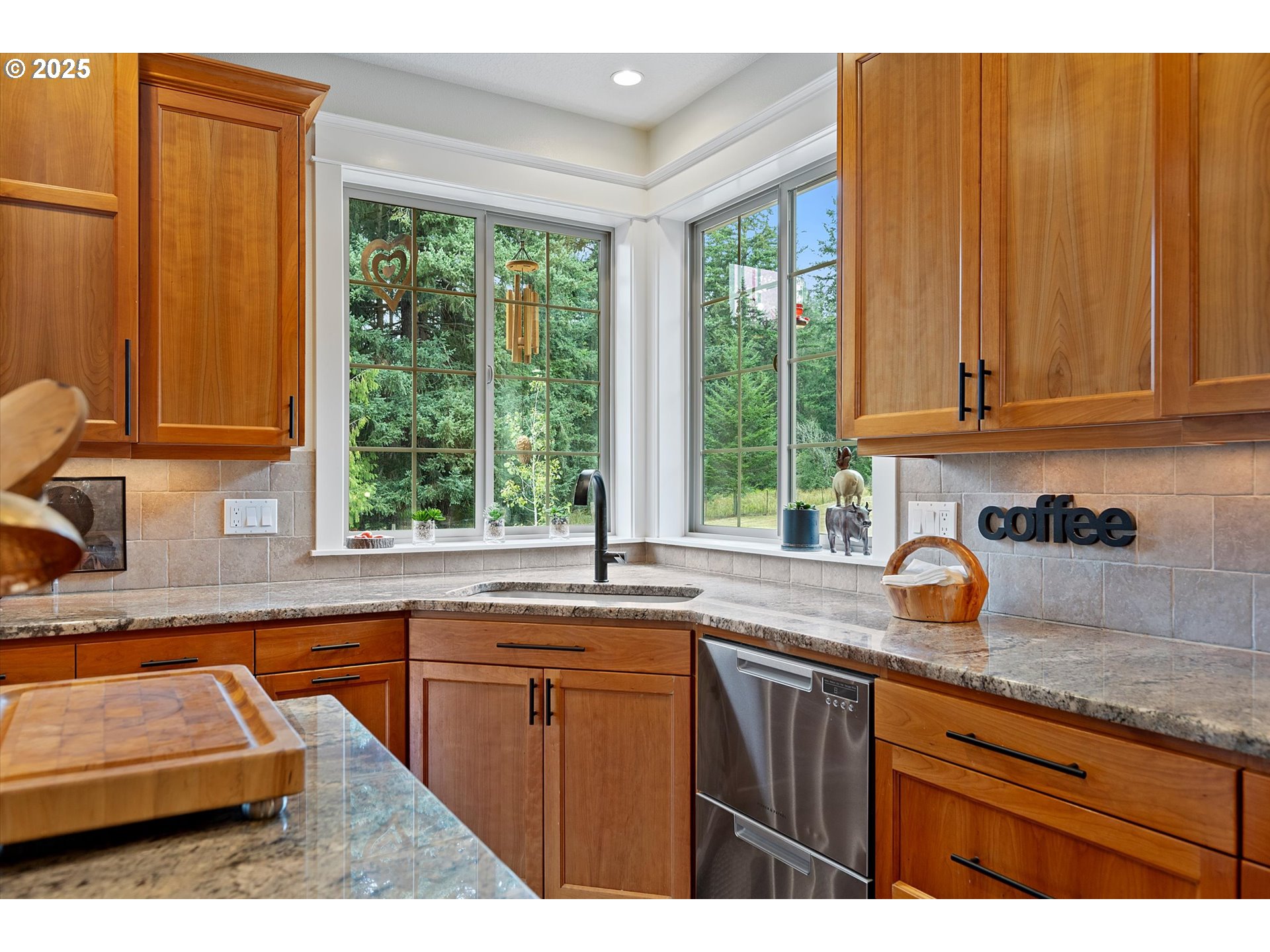 37212 South Sawtell Road Molalla, OR 97038 - Photo 12 of 46 a kitchen with granite countertop wooden cabinets a sink and a window
