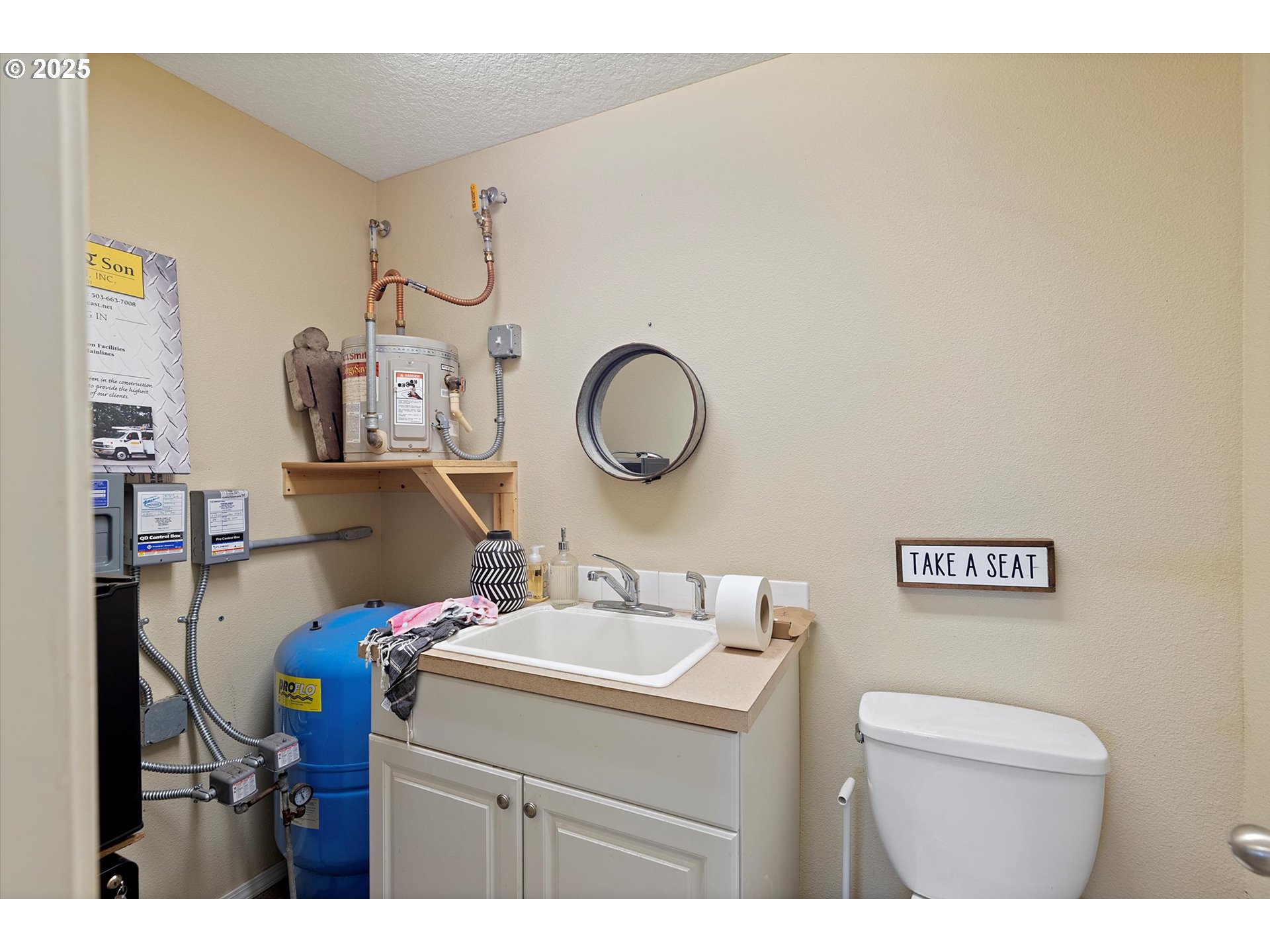 37212 South Sawtell Road Molalla, OR 97038 - Photo 36 of 46 a bathroom with a sink mirror vanity and toilet