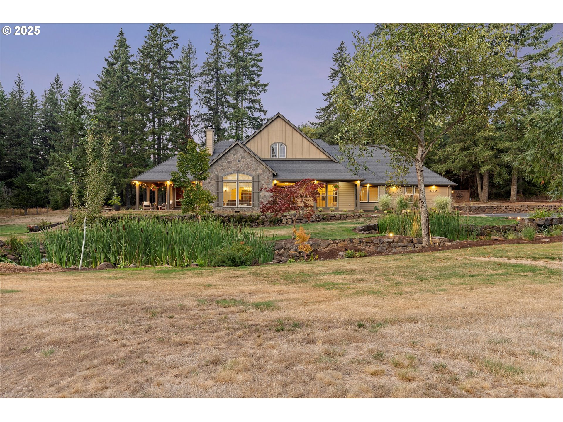 37212 South Sawtell Road Molalla, OR 97038 - Photo 43 of 46 a front view of a house with a yard and garage