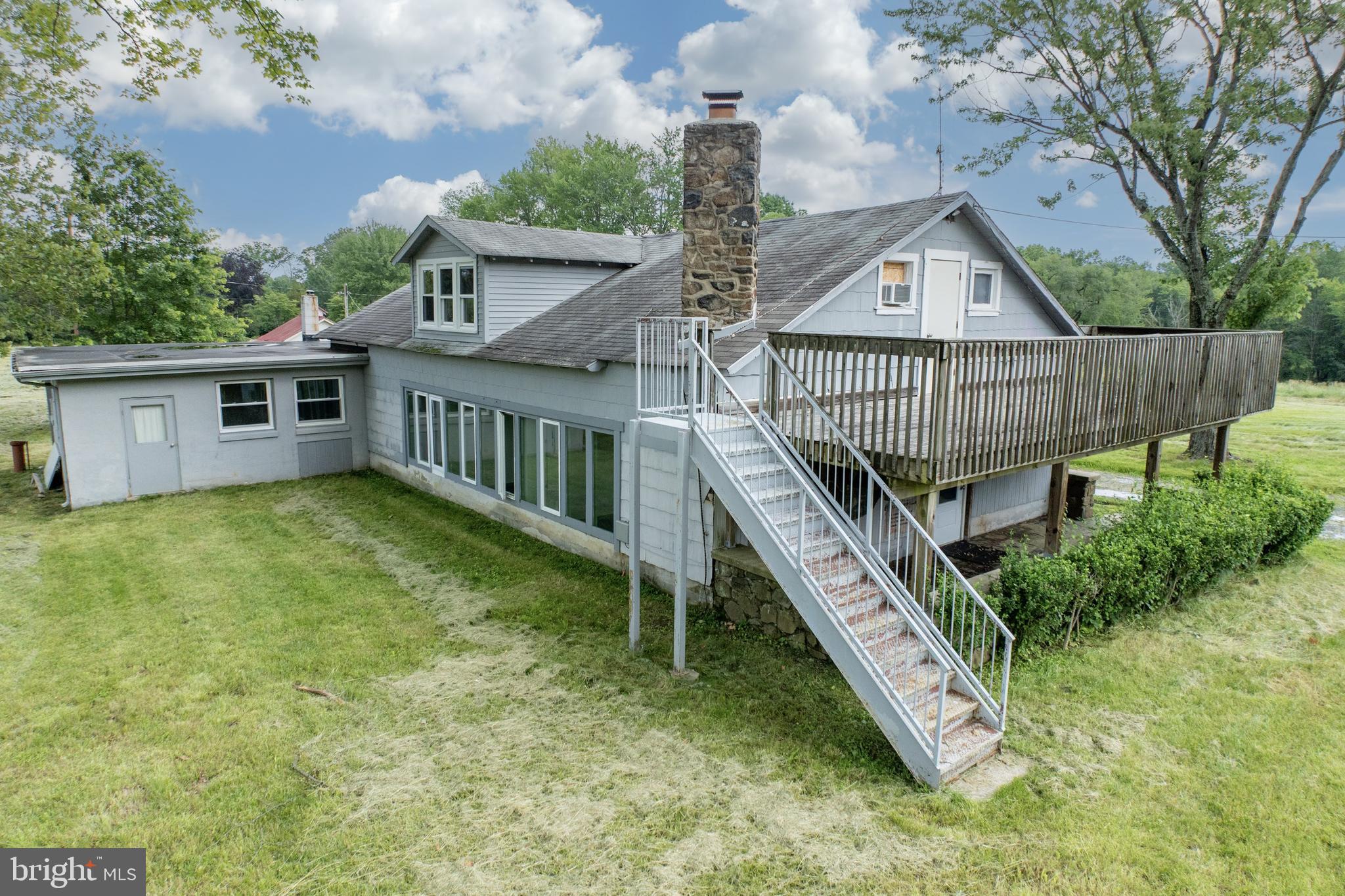 2488 Sanatoga Road Pottstown, PA 19464 - Photo 11 of 92 a view of a house with a wooden deck and a yard