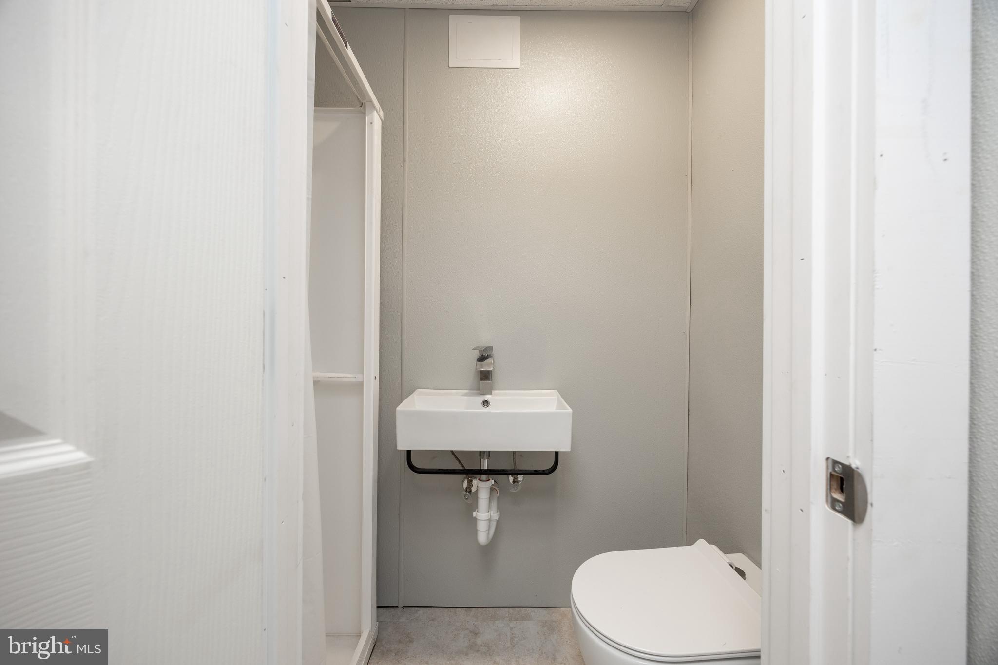 2488 Sanatoga Road Pottstown, PA 19464 - Photo 28 of 92 a bathroom with a sink a toilet and mirror