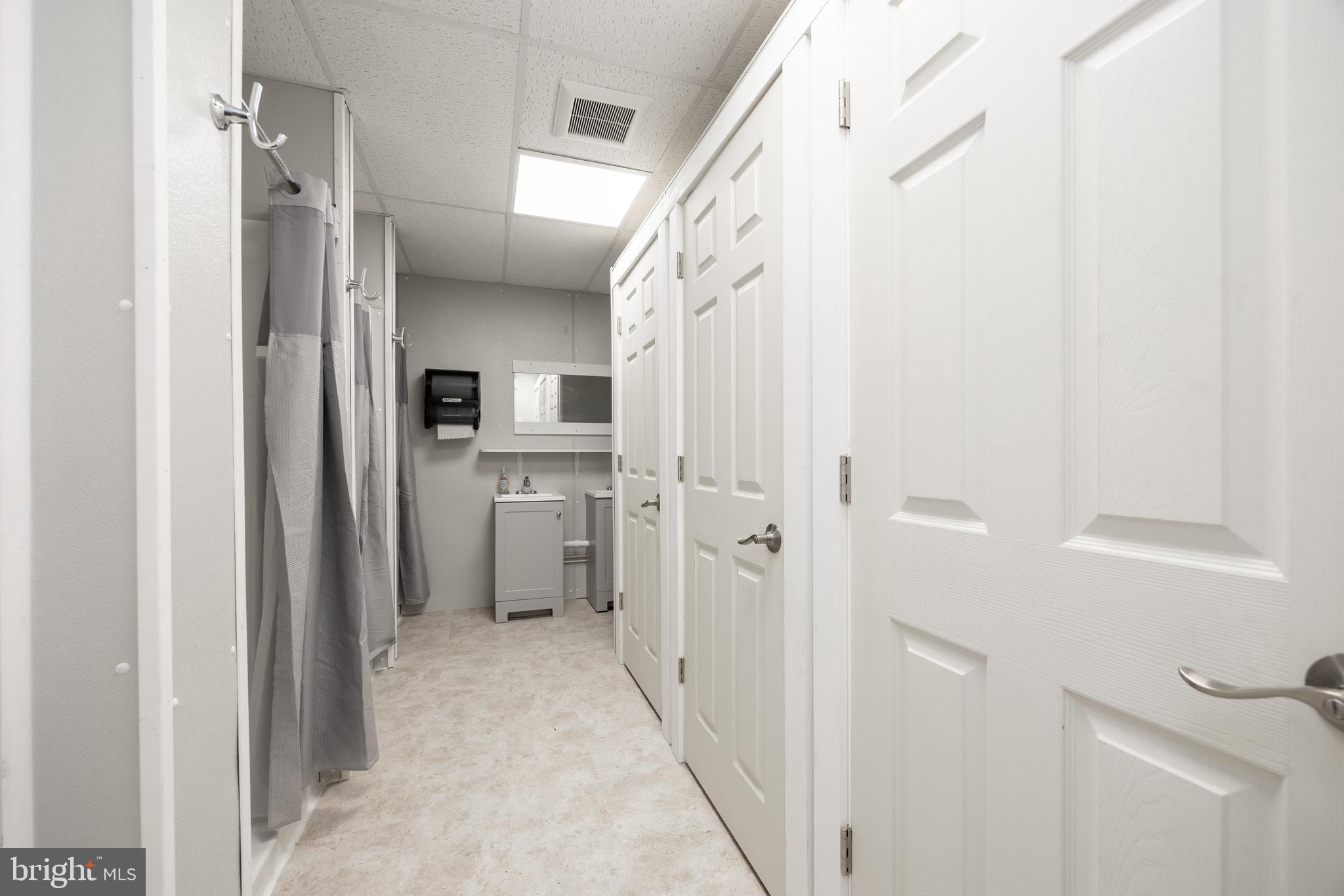 2488 Sanatoga Road Pottstown, PA 19464 - Photo 31 of 92 a view of a hallway with a white cabinet and a refrigerator