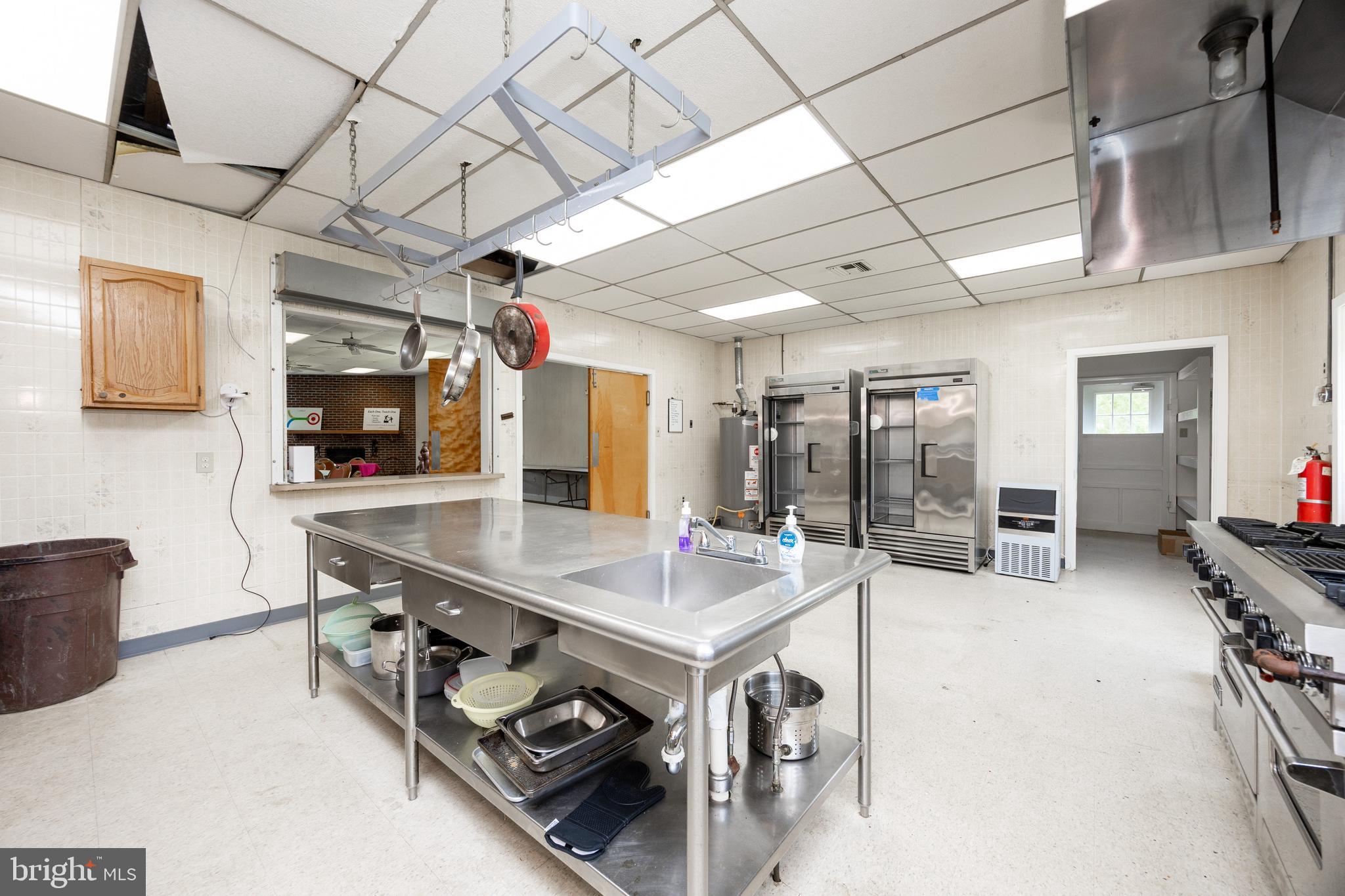 2488 Sanatoga Road Pottstown, PA 19464 - Photo 56 of 92 a kitchen with stainless steel appliances granite countertop a sink a stove and a wooden cabinets