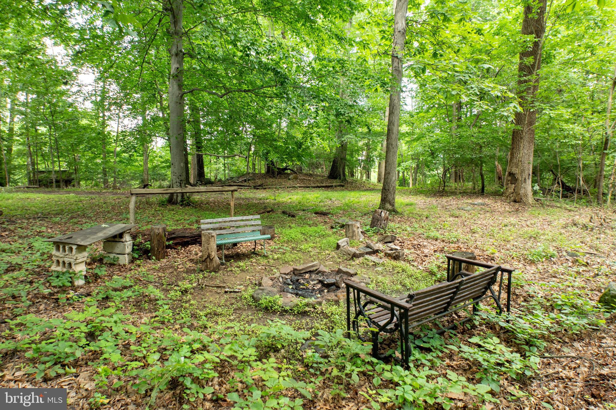 2488 Sanatoga Road Pottstown, PA 19464 - Photo 74 of 92 a view of a backyard with wooden fence and a bench
