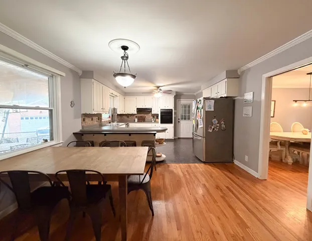 a large kitchen with a table and chairs
