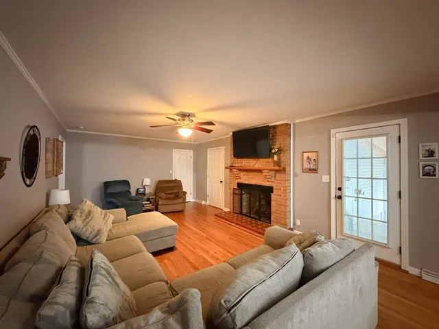 a living room with furniture a fireplace and a flat screen tv
