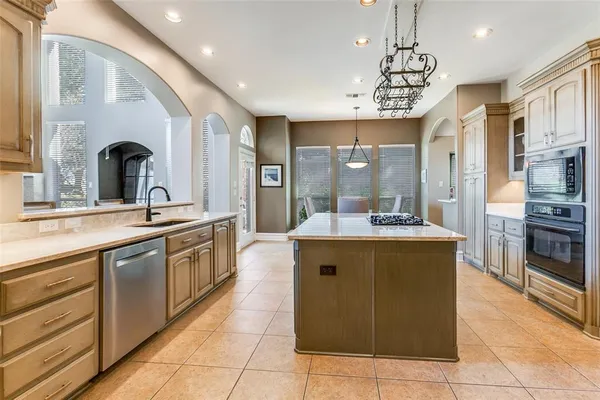 a kitchen with a sink stove and cabinets