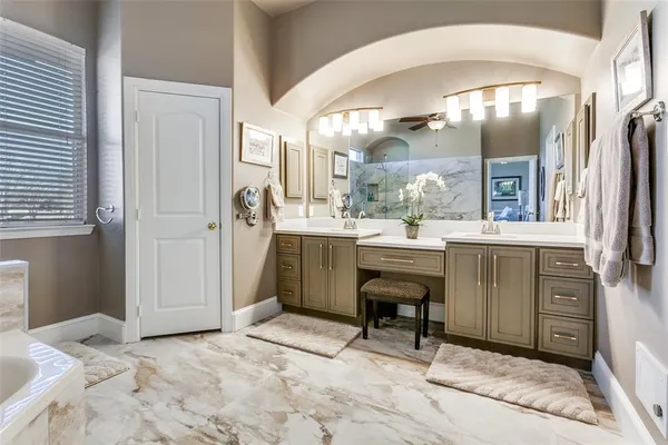 a bathroom with a tub sink and mirror