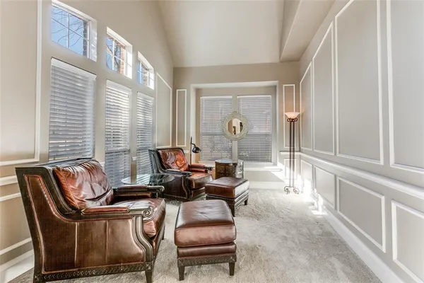a living room with furniture a fireplace and a large window