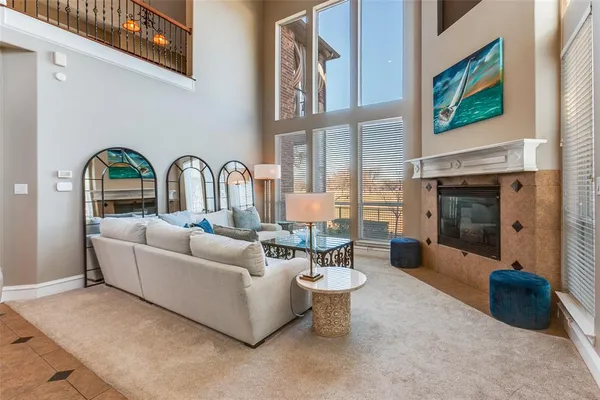 a living room with furniture a fireplace and next to a window