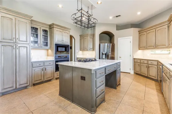 a kitchen with a sink counter top space appliances and cabinets