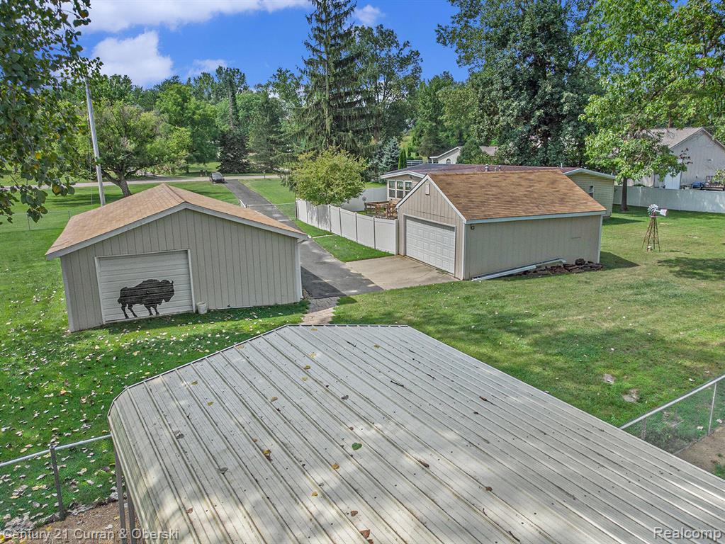 10228 Rexford Road Grass Lake, MI 49240 - Photo 21 of 24 Deck with an outbuilding and a garage