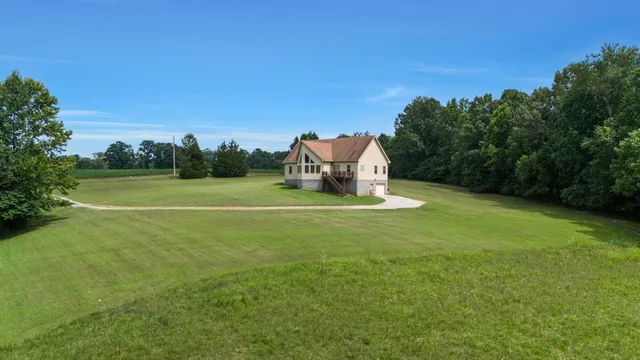 a view of a house with a yard and sitting area