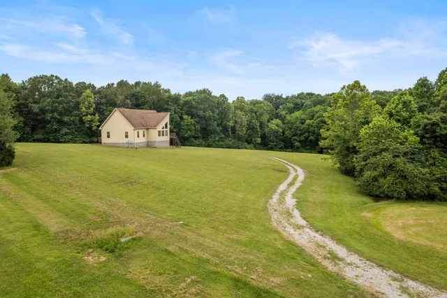 a house that has a big yard with wooden fence