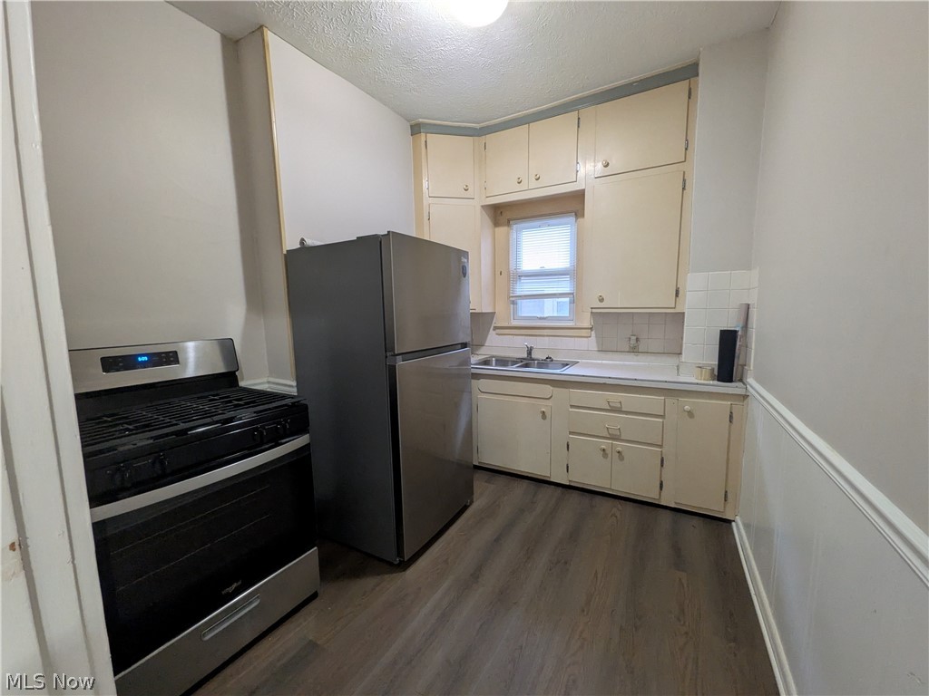 1881 Manchester Road, Unit 1 Akron, OH 44314 - Photo 25 of 44 1881 Manchester Rd, Akron, OH 44314 Unit #1 ground floor access and living. Welcome to this spacious 2-bedroom, 1-bathroom first-floor generous and remodeled apartment in the Kenmore neighborhood of Akron, offering a great amount of comfortable living space. This move-in ready apartment features LVP flooring throughout, a spacious living room, room for dining, separate kitchen with a gas range and stainless steel refrigerator, two bedrooms, and a full private bathroom which has a convenient step-in shower. Large windows provide natural light, while ample closets offer plenty of storage. Enjoy off-street parking and a backyard with a picnic table and small firepit, providing a pleasant outdoor space to relax and enjoy for the buildings tenants.