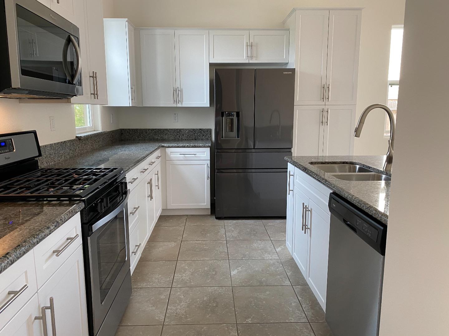 1233 La Colina Street Soledad, CA 93960 - Photo 2 of 10 a kitchen with a refrigerator stove and microwave