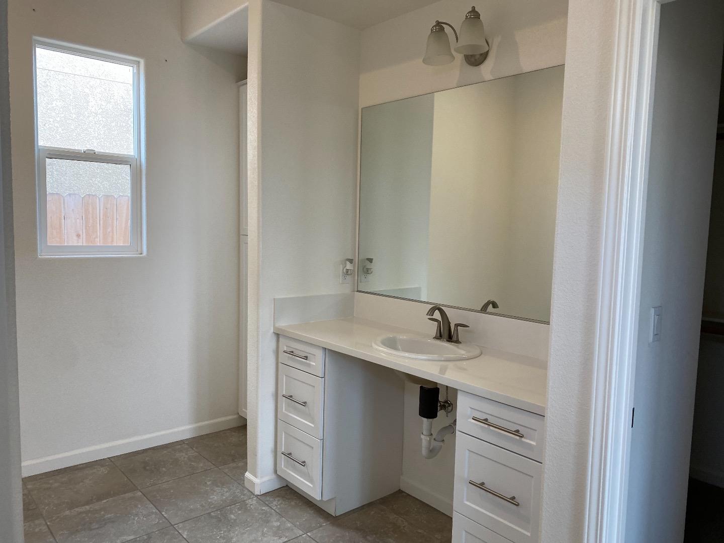 1233 La Colina Street Soledad, CA 93960 - Photo 8 of 10 a bathroom with a sink and a mirror