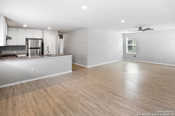 a view of a kitchen with a sink and wooden floor