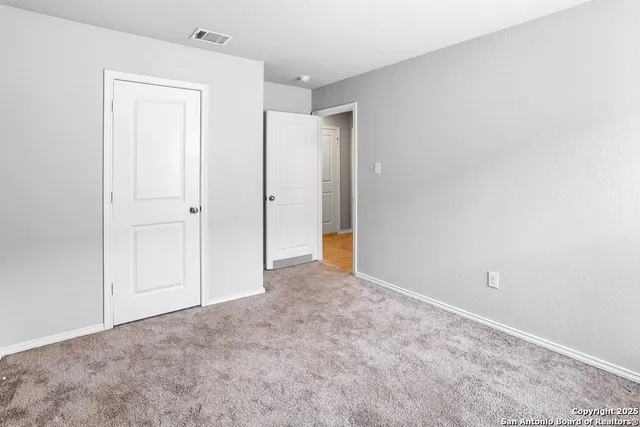 a bathroom with a granite countertop sink toilet a mirror and shower