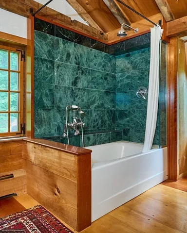 a bathroom with a bathtub and shower
