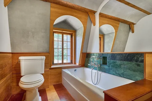 a bathroom with a toilet a sink and bathtub