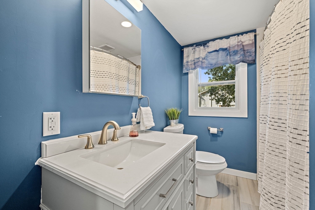 8 Elginwood Road Peabody, MA 01960 - Photo 11 of 25 a bathroom with a sink a toilet and a mirror