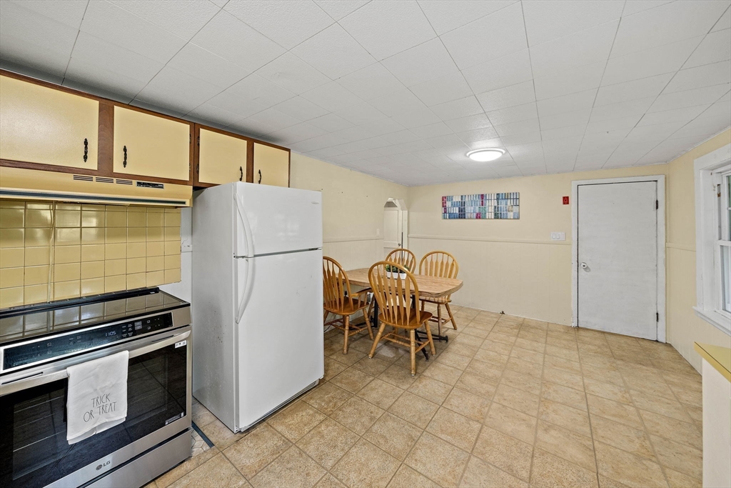 8 Elginwood Road Peabody, MA 01960 - Photo 6 of 25 a kitchen with a refrigerator and a stove top oven