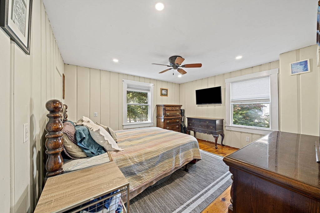 8 Elginwood Road Peabody, MA 01960 - Photo 8 of 25 a bedroom with a bed a large window and flat screen tv