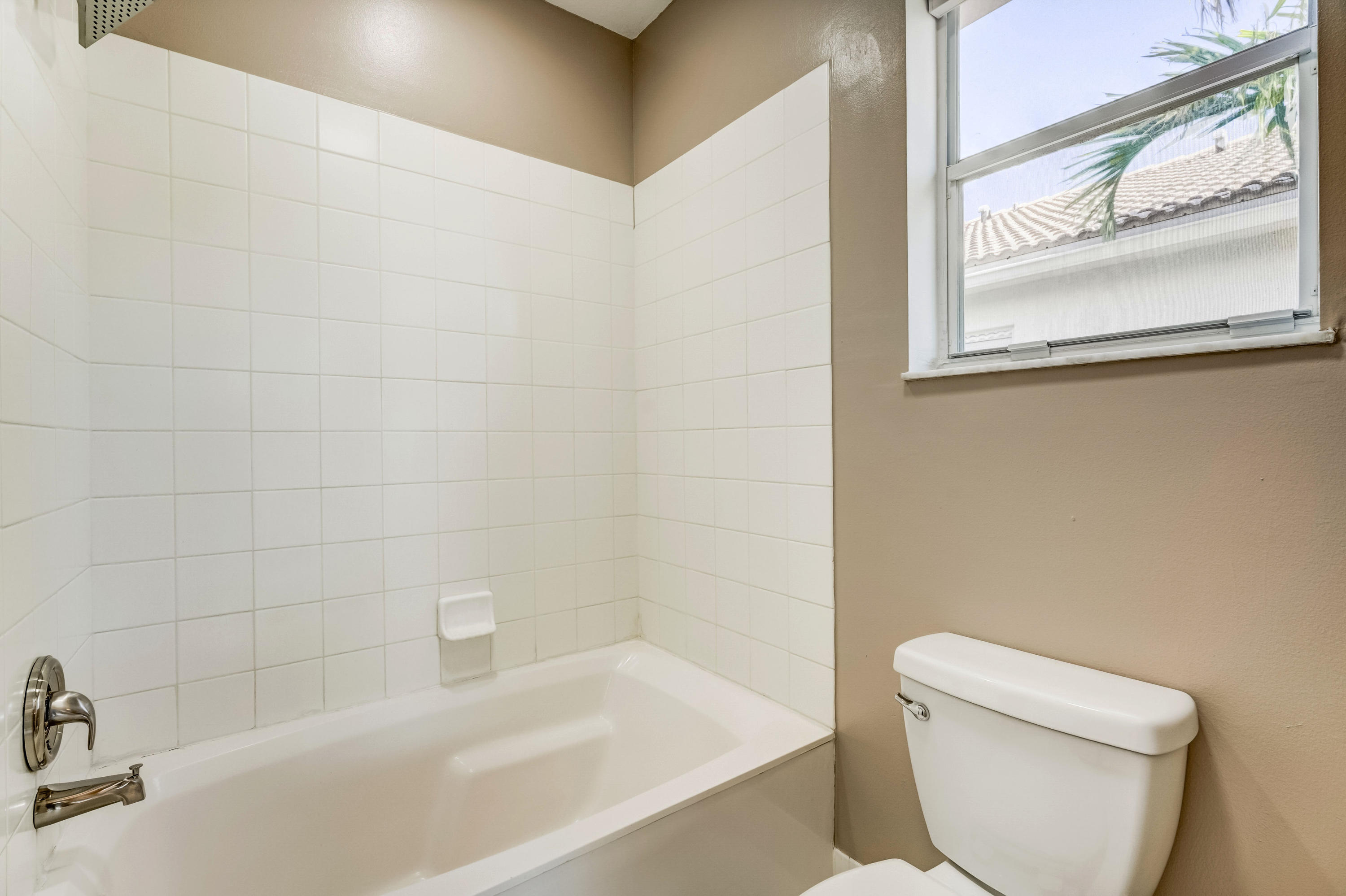 3174 Laurel Ridge Circle Riviera Beach, FL 33404 - Photo 21 of 32 a white toilet sitting next to a bath tub