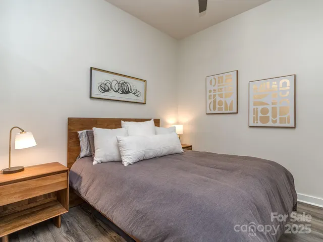 a bedroom with bed and painting on the wall