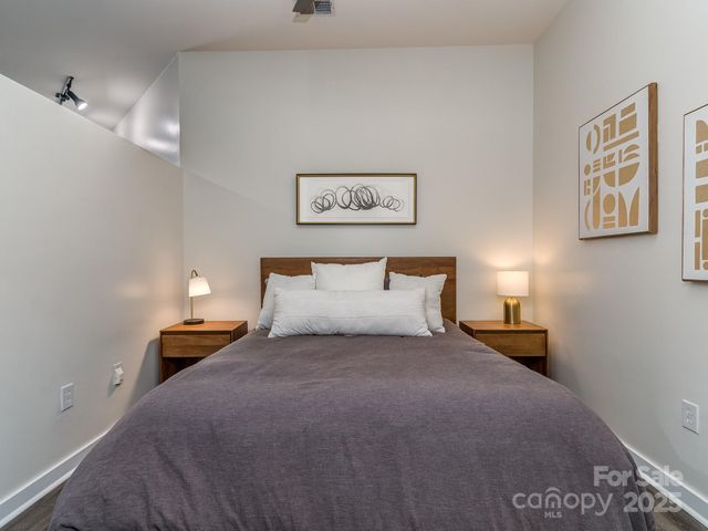 a bedroom with a bed and a lamp