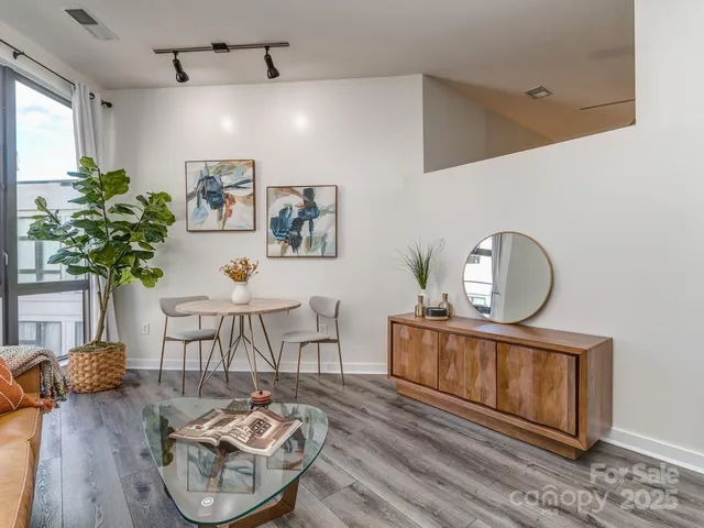 a living room with furniture a dining table with wooden floor