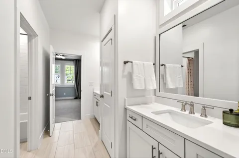 a bathroom with a sink vanity granite and a mirror